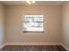Inviting bedroom with wood-look floors, a window, and natural light at 8436 Cameo St, Spring Hill, FL 34608