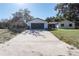 Charming single-story home featuring a well-manicured lawn and a spacious driveway leading to a two-car garage at 8436 Cameo St, Spring Hill, FL 34608