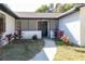 Inviting front entrance with a dark door and landscaping at 8436 Cameo St, Spring Hill, FL 34608