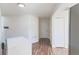 Well-lit hallway with wood-look floors and white trim at 8436 Cameo St, Spring Hill, FL 34608