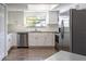 Modern kitchen with stainless steel appliances, granite countertops, and white cabinets at 8436 Cameo St, Spring Hill, FL 34608