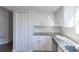 Bright kitchen with white cabinets, granite countertops, and convenient pantry space at 8436 Cameo St, Spring Hill, FL 34608