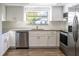 Modern kitchen with stainless steel appliances, granite countertops, and white cabinets at 8436 Cameo St, Spring Hill, FL 34608