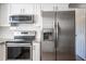 Kitchen featuring stainless steel appliances, granite countertops, and crisp white cabinetry at 8436 Cameo St, Spring Hill, FL 34608