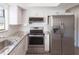 Well-equipped kitchen with stainless steel appliances, granite countertops, and white cabinets at 8436 Cameo St, Spring Hill, FL 34608