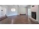 Open-concept living area with hardwood floors, fireplace, and unique architectural details at 8436 Cameo St, Spring Hill, FL 34608
