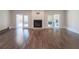 Bright living room with hardwood floors, fireplace, and french doors leading to backyard at 8436 Cameo St, Spring Hill, FL 34608