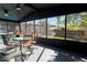 The large screened porch has great views of the yard, ceiling fans and ample seating at 8436 Cameo St, Spring Hill, FL 34608