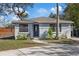 Charming single-story home with a well-manicured lawn and inviting entryway at 9403 W Perio Pl, Tampa, FL 33612