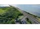 Beautiful aerial view of the property's proximity to the waterfront and surrounding greenery at 14 Seagrape Cir, Clearwater, FL 33759