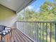 Balcony with wooded view, railing and outside furniture at 14 Seagrape Cir, Clearwater, FL 33759