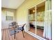 Balcony with outdoor furniture, view into bedroom with sliding glass door at 14 Seagrape Cir, Clearwater, FL 33759
