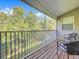 Relaxing balcony with wooded view, chairs and wood flooring at 14 Seagrape Cir, Clearwater, FL 33759