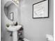 Bathroom featuring a pedestal sink, a framed quote, and modern fixtures at 14 Seagrape Cir, Clearwater, FL 33759