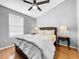 Bedroom with modern ceiling fan, hardwood floors, and large bed at 14 Seagrape Cir, Clearwater, FL 33759