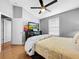 Bedroom with ceiling fan, large bed, window, and TV at 14 Seagrape Cir, Clearwater, FL 33759