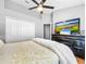 Bedroom with ceiling fan, flat screen TV, and large closet at 14 Seagrape Cir, Clearwater, FL 33759
