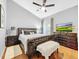 Bedroom features hardwood floors, ceiling fan, balcony access and closet at 14 Seagrape Cir, Clearwater, FL 33759