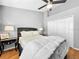 Bedroom with ceiling fan, bedside lamps, and hardwood floors at 14 Seagrape Cir, Clearwater, FL 33759