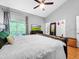 Bedroom boasts hardwood floors, ceiling fan, balcony, and en-suite bathroom at 14 Seagrape Cir, Clearwater, FL 33759