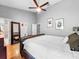 Bright bedroom with hardwood floors, ceiling fan, and decor at 14 Seagrape Cir, Clearwater, FL 33759