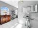Hallway with a wood cabinet, large windows, and a decorative mirror at 14 Seagrape Cir, Clearwater, FL 33759