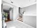 Hallway featuring tile floors, stairs to the upper level, and natural light at 14 Seagrape Cir, Clearwater, FL 33759