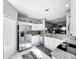 Spacious kitchen features white cabinets, granite countertops, and stainless steel refrigerator at 14 Seagrape Cir, Clearwater, FL 33759