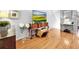 An elegant living room is showcased with hardwood floors, stylish furniture, and a large screen television at 14 Seagrape Cir, Clearwater, FL 33759