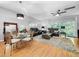 Open living space featuring hardwood flooring, a dining area, and a cozy seating area with a plush rug at 14 Seagrape Cir, Clearwater, FL 33759