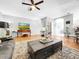 Cozy living room featuring hardwood floors, a ceiling fan, and stylish decor at 14 Seagrape Cir, Clearwater, FL 33759
