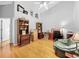 Bright office with hardwood floors, ceiling fan, desk and shelving at 14 Seagrape Cir, Clearwater, FL 33759