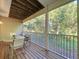 Screened-in patio with a dining table and serene views of nature at 14 Seagrape Cir, Clearwater, FL 33759