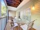 Cozy screened patio features an outdoor dining set and natural light at 14 Seagrape Cir, Clearwater, FL 33759