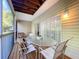 Cozy screened patio features an outdoor dining set and natural light at 14 Seagrape Cir, Clearwater, FL 33759