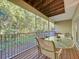 Screened lanai with outdoor dining table surrounded by lush greenery at 14 Seagrape Cir, Clearwater, FL 33759