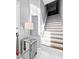 Elegant staircase featuring white risers, wood treads, and stylish decor, creating a welcoming entryway at 14 Seagrape Cir, Clearwater, FL 33759