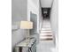 Bright staircase with white risers and wooden treads, complemented by modern decor and light gray walls at 14 Seagrape Cir, Clearwater, FL 33759