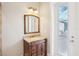 Bathroom vanity features a wood cabinet, granite countertop, and decorative mirror, and pool view at 11145 Mountain Mockingbird Rd, Weeki Wachee, FL 34614