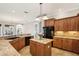 Beautiful kitchen featuring granite countertops, wood cabinets, and sleek black appliances at 11145 Mountain Mockingbird Rd, Weeki Wachee, FL 34614