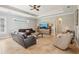 Cozy living room boasting a tray ceiling, neutral decor, and seamless flow to other living spaces at 11145 Mountain Mockingbird Rd, Weeki Wachee, FL 34614