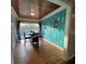 Dining room with wood floors, a unique accent wall, and a sliding glass door to the outside at 1564 S Michigan Ave, Clearwater, FL 33756