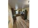 Well-lit kitchen with wood-look tile flooring, stainless steel appliances, and dark cabinets at 1564 S Michigan Ave, Clearwater, FL 33756
