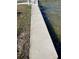 Waterfront property featuring a concrete seawall along the canal at 16103 4Th E St, Redington Beach, FL 33708