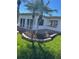 Exterior view of the property with a well-maintained lawn, mature palms, and a comfortable outdoor deck at 16103 4Th E St, Redington Beach, FL 33708