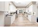 Modern kitchen features white cabinets, stone counters, and stainless appliances at 16103 4Th E St, Redington Beach, FL 33708