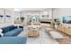Bright living room features fireplace, plush seating, and view to water at 16103 4Th E St, Redington Beach, FL 33708