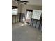 Unfinished room needing renovation, showcasing a ceiling fan, a window, a doorway, and a decorative glass block window at 16103 4Th E St, Redington Beach, FL 33708