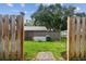 View of fenced in backyard from the gate at 211 Somerset Cirle N, Dunedin, FL 34698