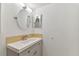 Updated bathroom with a gray vanity, decorative mirrors and updated light fixture at 211 Somerset Cirle N, Dunedin, FL 34698